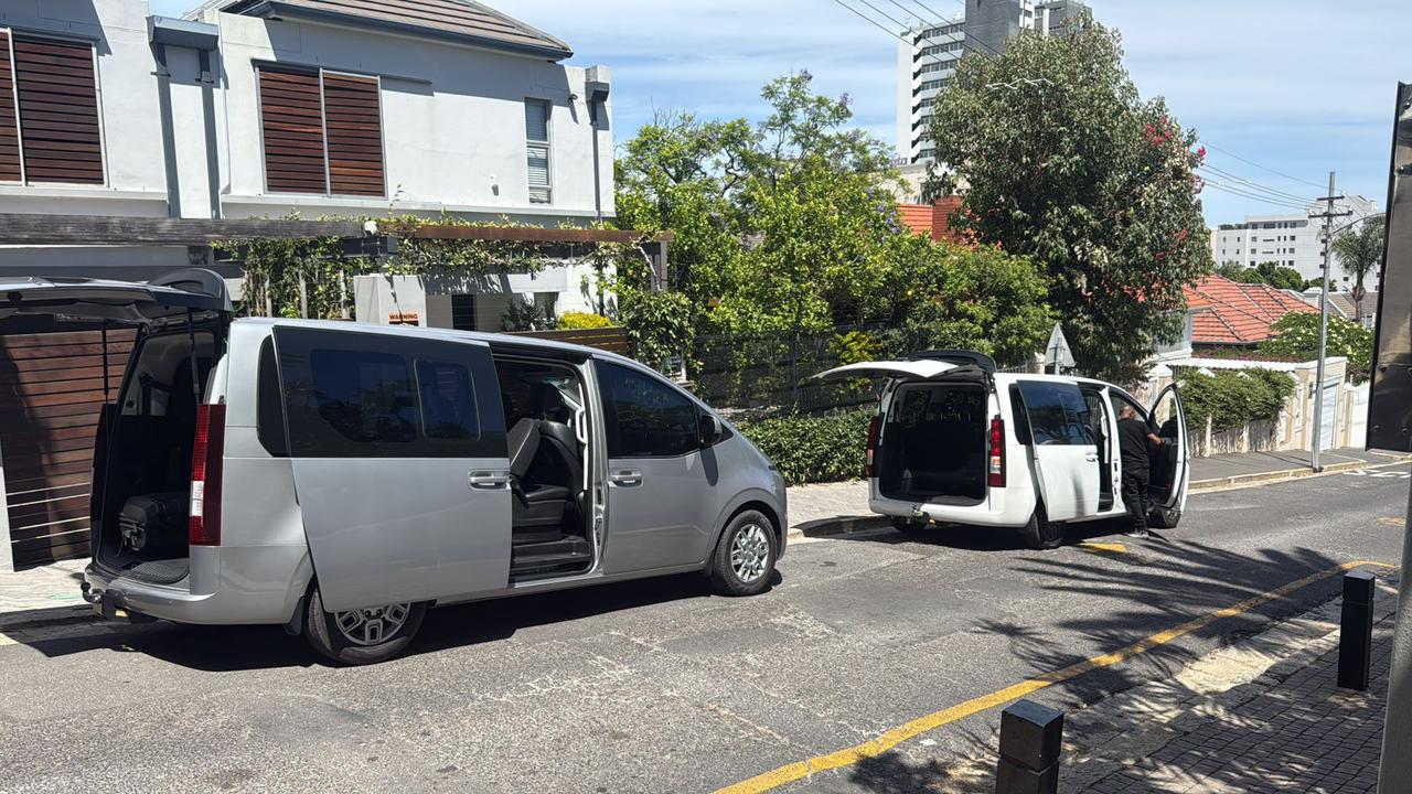 Two passenger vans with doors open ready for boarding