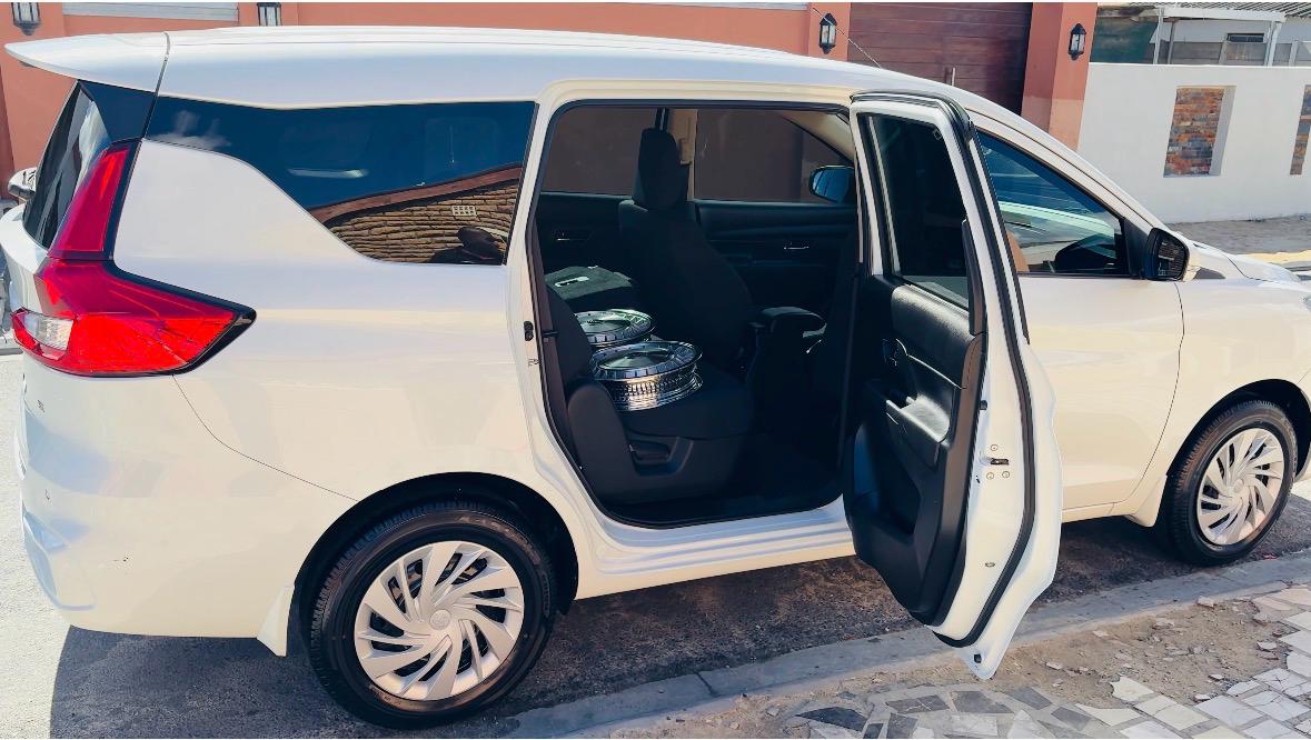 White minivan with sliding door open showing interior seating
